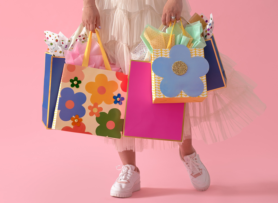 Young female carrying colorful gift bags